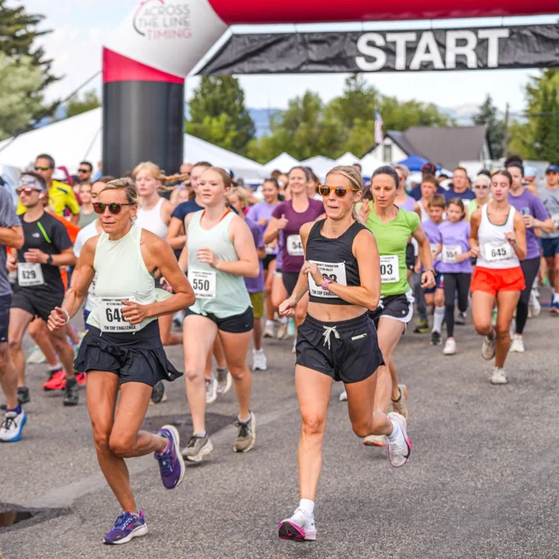 Runners setting off under the START banner at the Tin Cup Challenge